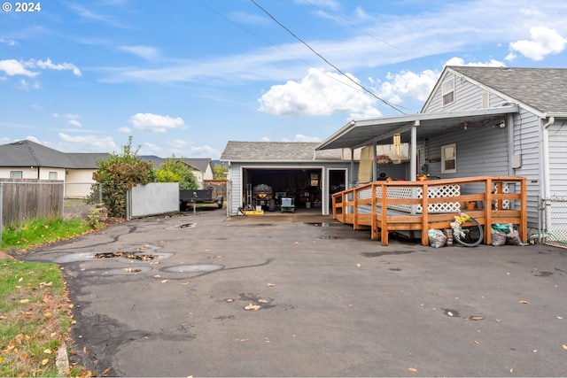 exterior space featuring a wooden deck and a garage