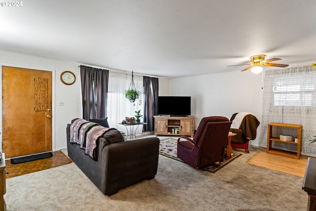 carpeted living room featuring ceiling fan