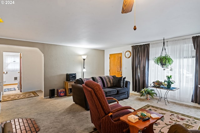 living room with light carpet and ceiling fan