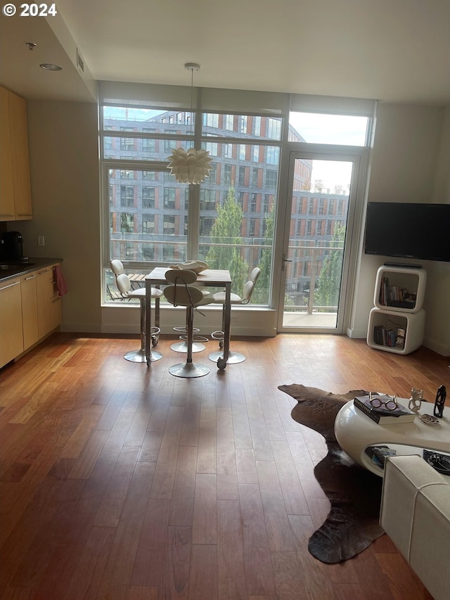 dining area with light hardwood / wood-style floors and a notable chandelier