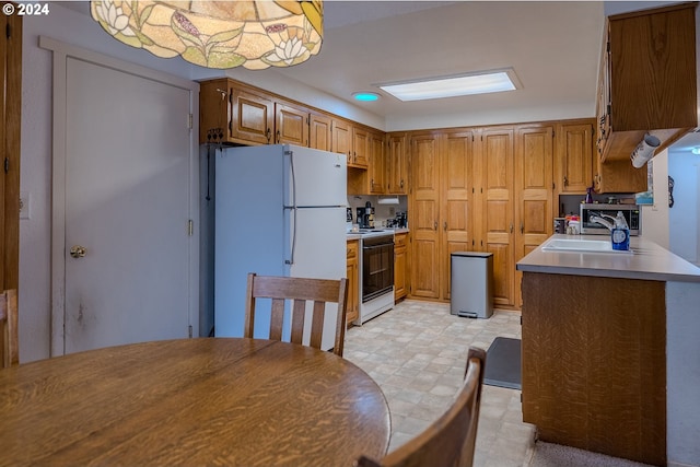 kitchen featuring white appliances and sink