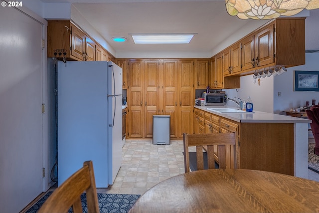 kitchen featuring sink and white refrigerator