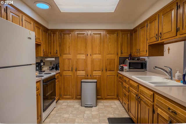 kitchen featuring sink and white appliances