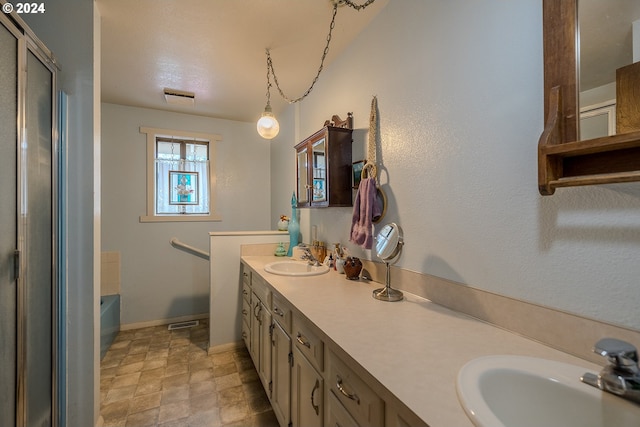 bathroom with vanity, a bath, and a textured ceiling