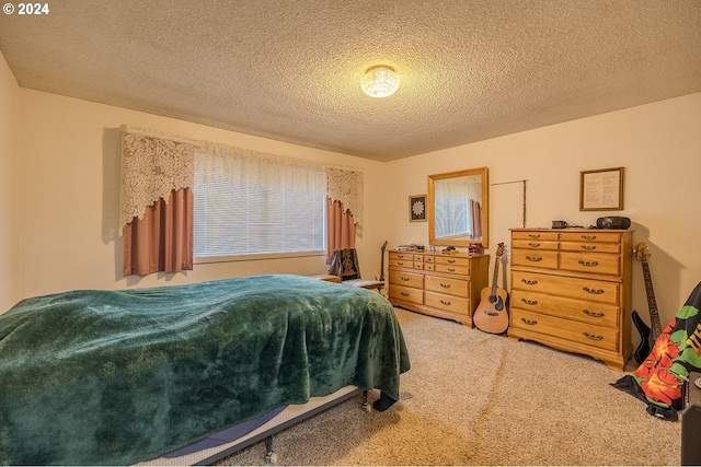 bedroom featuring carpet and a textured ceiling