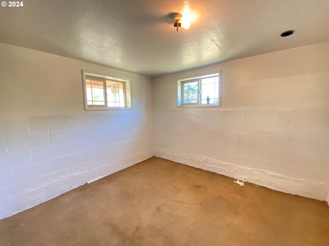 basement with a healthy amount of sunlight and carpet