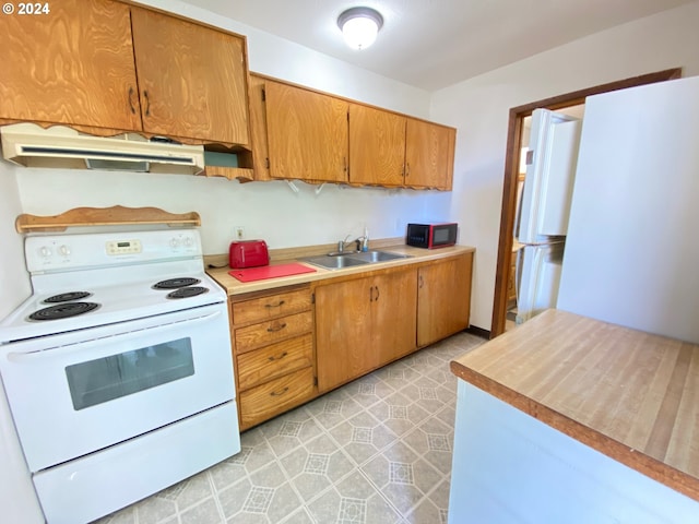 kitchen with sink and white appliances