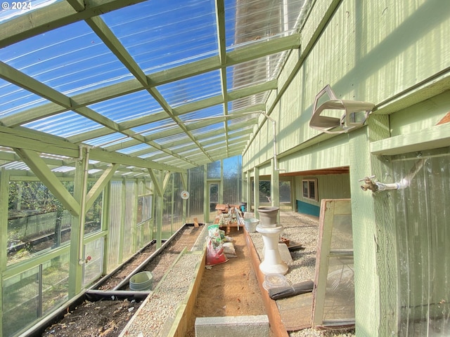 sunroom featuring vaulted ceiling