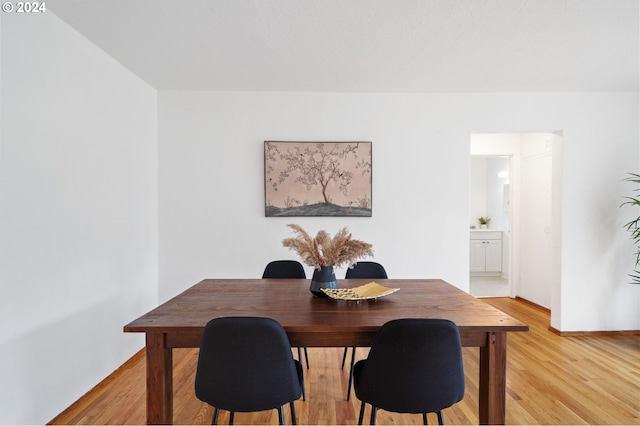 dining area with light hardwood / wood-style floors