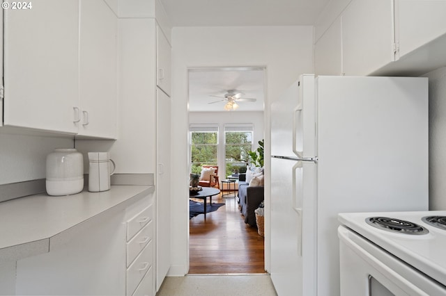 kitchen with white cabinets, electric stove, light countertops, and ceiling fan
