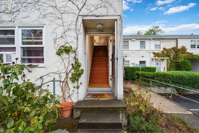 entrance to property with stucco siding