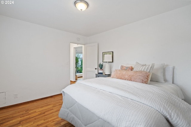 bedroom with wood-type flooring