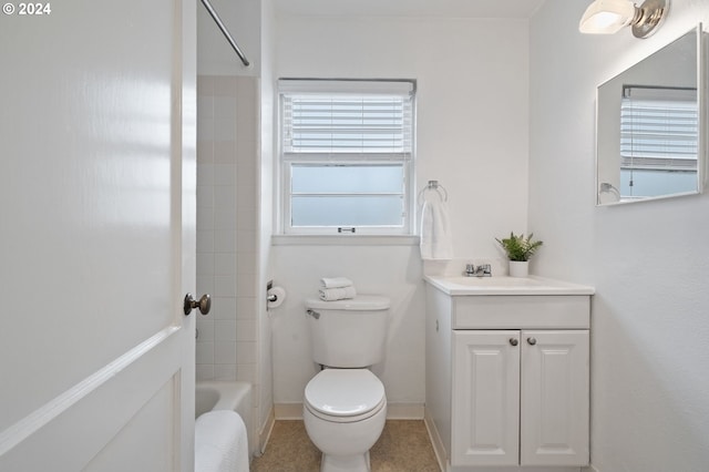 full bathroom featuring tiled shower / bath combo, vanity, and toilet