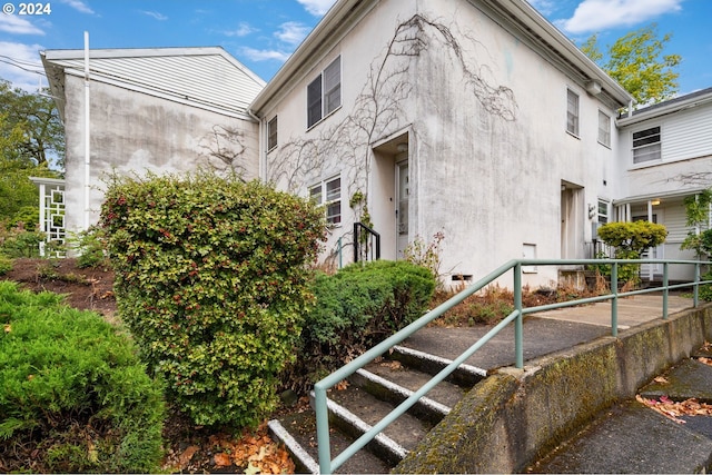 view of side of property with stucco siding