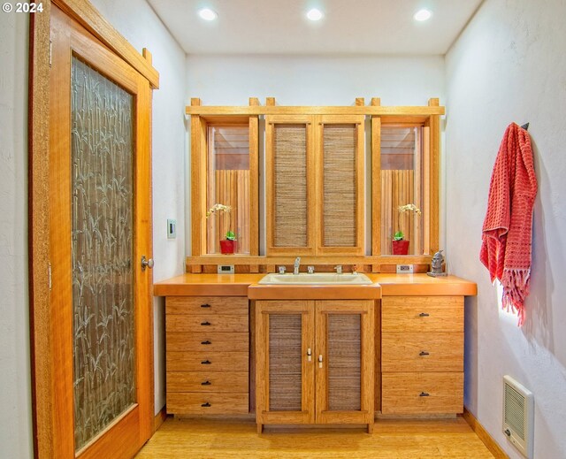 2275 Floral Hill Dr, Eugene, OR 97403 - bathroom featuring hardwood / wood-style floors and vanity