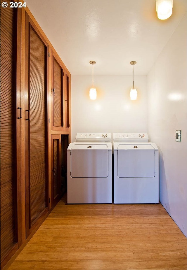 2275 Floral Hill Dr, Eugene, OR 97403 - laundry room with light wood-type flooring and separate washer and dryer