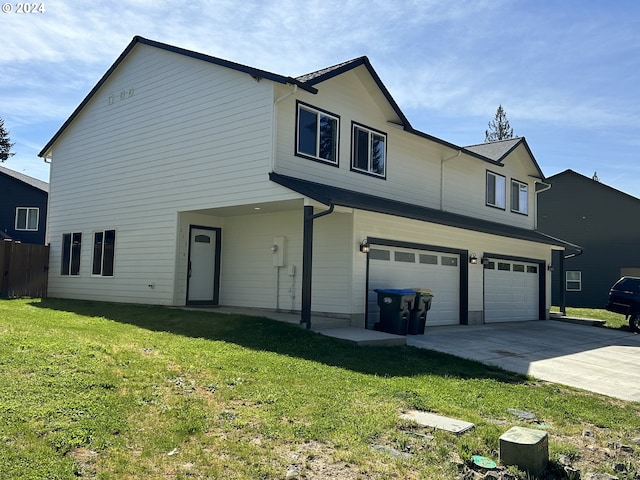 view of front of property with a front yard and a garage