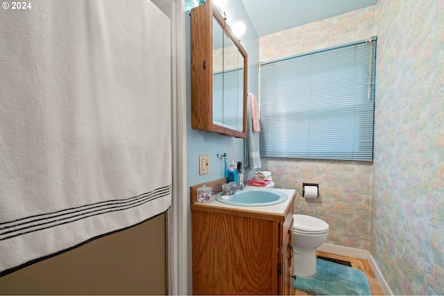 bathroom featuring vanity and toilet