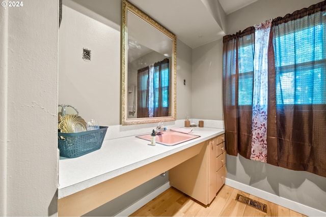 bathroom featuring hardwood / wood-style floors, vanity, and plenty of natural light