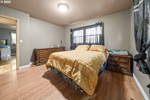 bedroom with light hardwood / wood-style floors