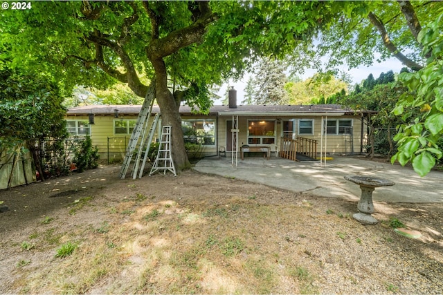 rear view of property featuring a patio area