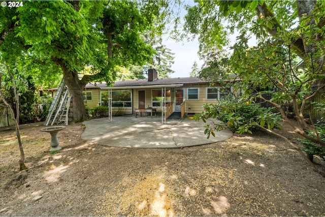 rear view of property featuring a patio area