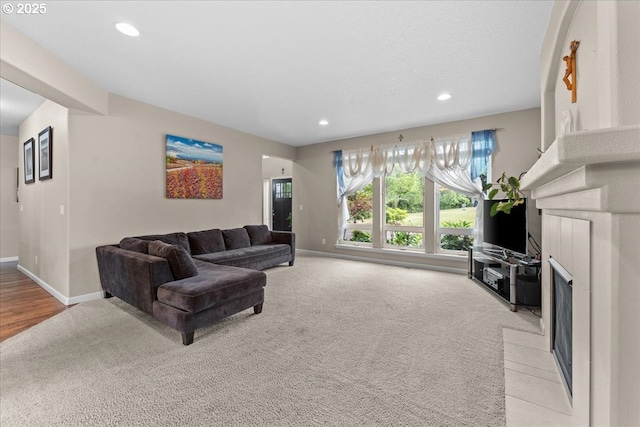 5898 SE Thornapple St, Hillsboro, OR 97123 - living area featuring light colored carpet, a tiled fireplace, baseboards, and recessed lighting