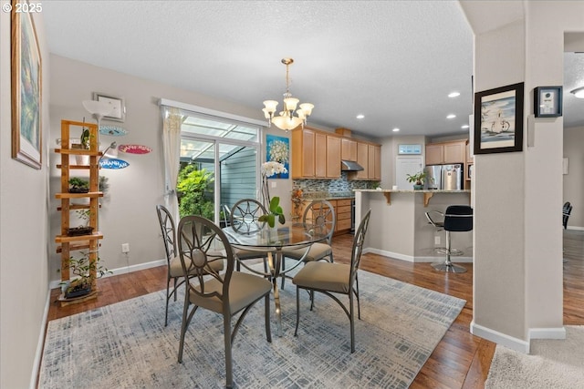 5898 SE Thornapple St, Hillsboro, OR 97123 - dining space featuring light wood-style flooring, a chandelier, baseboards, recessed lighting, and a textured ceiling