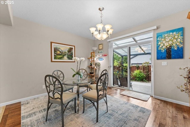 5898 SE Thornapple St, Hillsboro, OR 97123 - dining room featuring baseboards, wood finished floors, and a chandelier