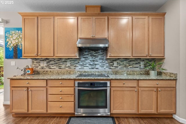 5898 SE Thornapple St, Hillsboro, OR 97123 - kitchen with oven, under cabinet range hood, black electric cooktop, and light wood-style flooring