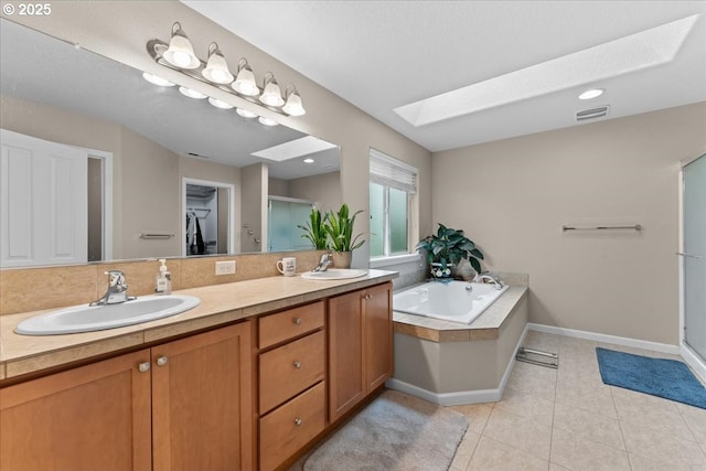 5898 SE Thornapple St, Hillsboro, OR 97123 - bathroom with a skylight, double vanity, a bath, a stall shower, and tile patterned flooring