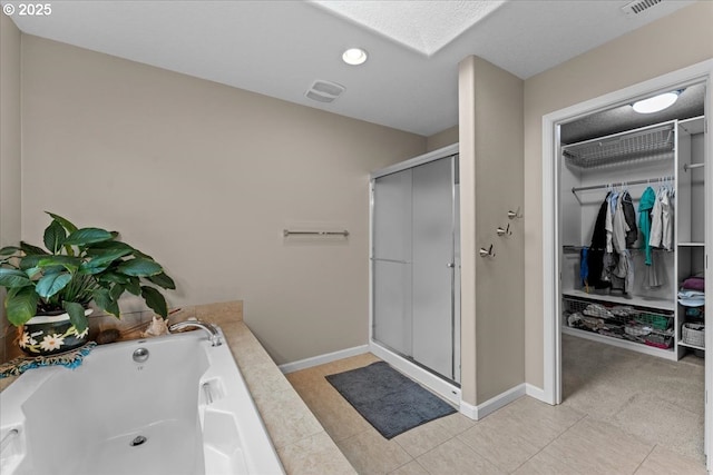 5898 SE Thornapple St, Hillsboro, OR 97123 - full bathroom with a shower stall, a jetted tub, a spacious closet, recessed lighting, and baseboards
