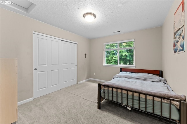 5898 SE Thornapple St, Hillsboro, OR 97123 - bedroom with a textured ceiling, carpet flooring, a closet, and baseboards