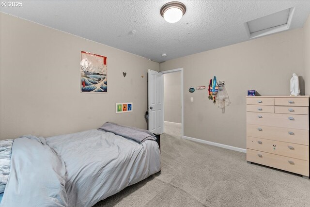 5898 SE Thornapple St, Hillsboro, OR 97123 - bedroom featuring attic access, light carpet, a textured ceiling, and baseboards
