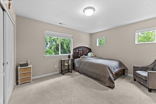 5898 SE Thornapple St, Hillsboro, OR 97123 - bedroom with a closet, a textured ceiling, carpet floors, and baseboards