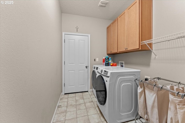 5898 SE Thornapple St, Hillsboro, OR 97123 - laundry area with washer and clothes dryer, cabinet space, baseboards, and a textured ceiling