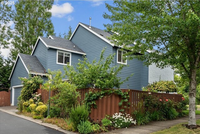 5898 SE Thornapple St, Hillsboro, OR 97123 - view of home's exterior featuring a shingled roof and a garage