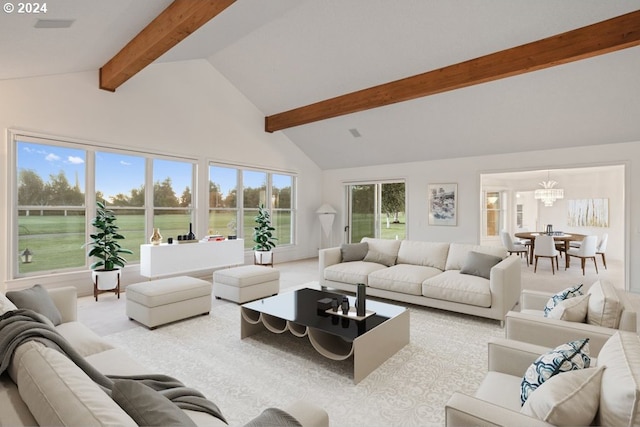 carpeted living room with beam ceiling, an inviting chandelier, and high vaulted ceiling