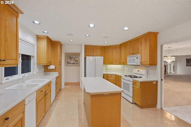 kitchen with sink, a chandelier, white appliances, and a center island