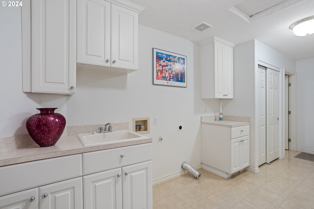 laundry area featuring washer hookup, electric dryer hookup, cabinets, gas dryer hookup, and sink