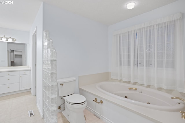 bathroom featuring vanity, toilet, and a washtub