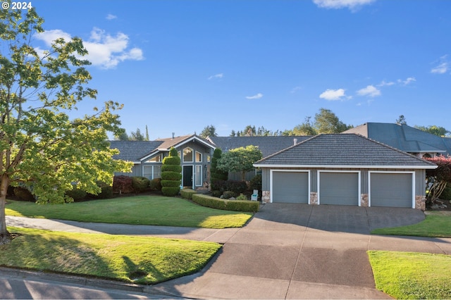 single story home featuring a garage and a front lawn