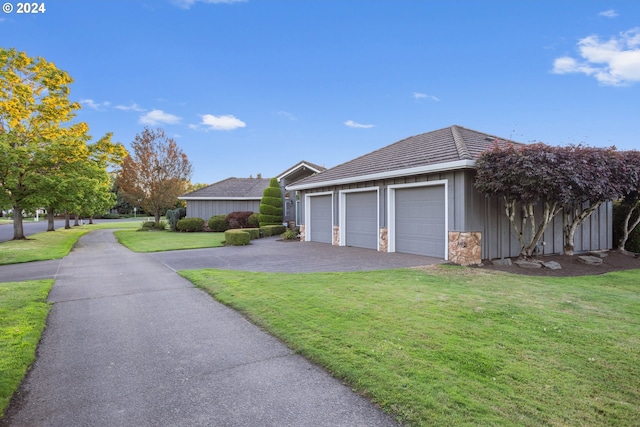 view of home's exterior featuring a lawn and a garage