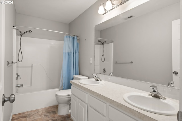 full bathroom featuring shower / bath combo, vanity, and toilet