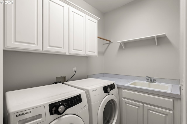 laundry area with cabinets, sink, and washer and clothes dryer