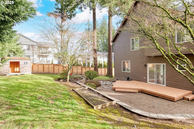 view of yard with a deck and a storage shed