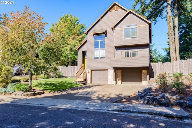 view of front of property featuring a front lawn and a garage