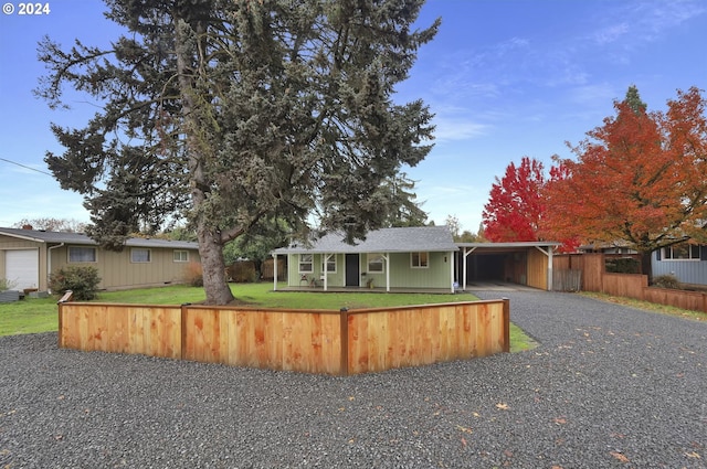 ranch-style house featuring a front yard and a carport