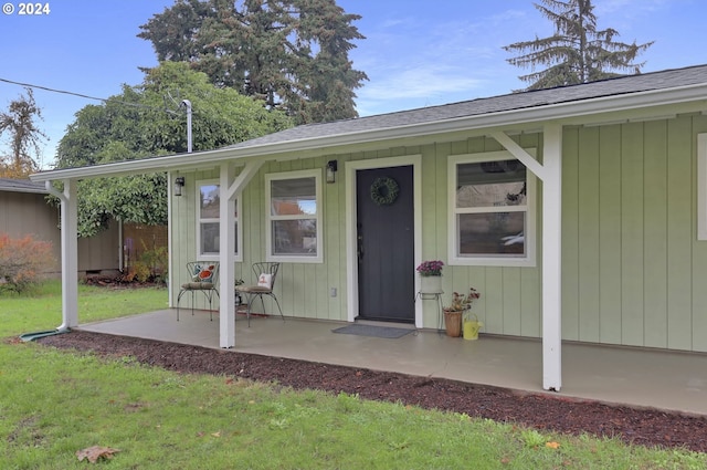 property entrance with a yard