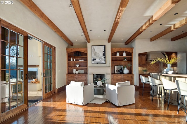 living room with beamed ceiling, dark hardwood / wood-style floors, and french doors